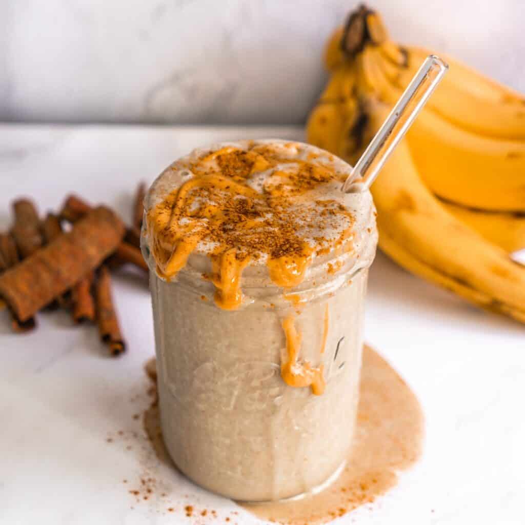 A healthy green peanut butter banana protein shake with cinnamon, spinach, and flaxseeds.