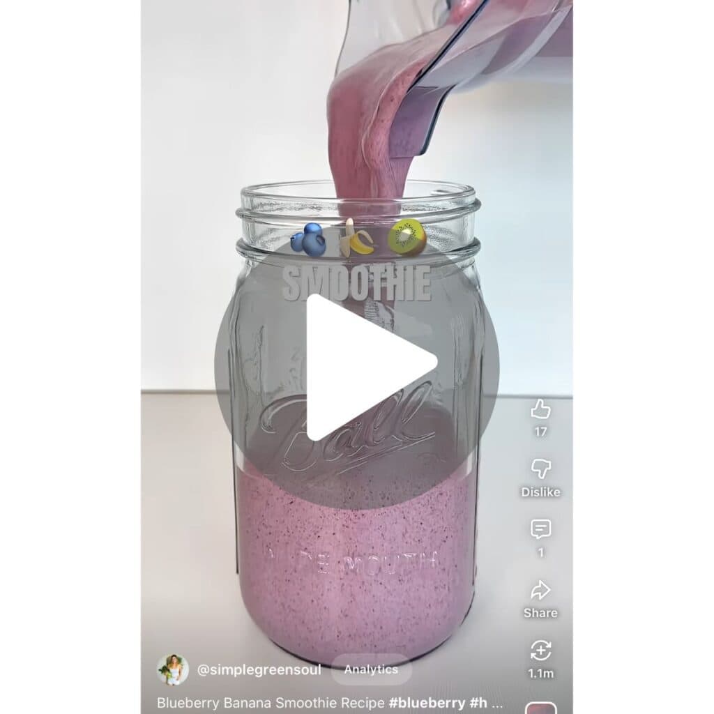 A YouTube Shorts video screenshot of a blueberry banana kiwi smoothie with superfood seeds being blended, with a link to watch the full tutorial.