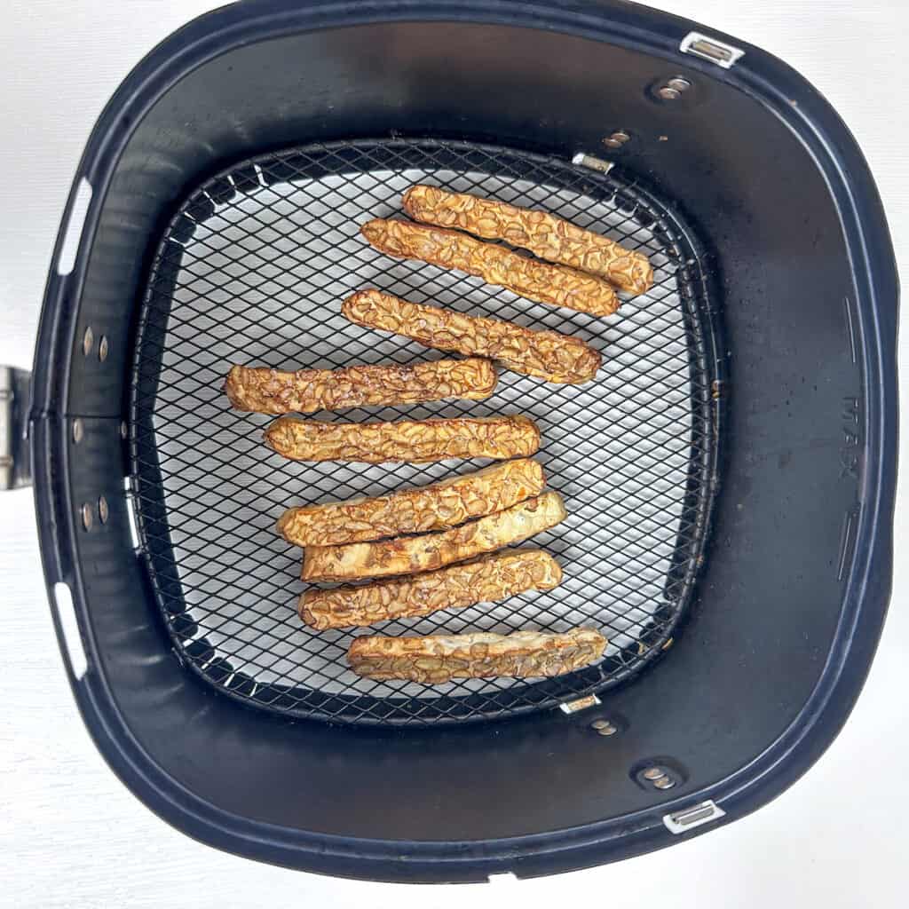 Crispy golden brown strips in a basket, air fryer tempeh.
