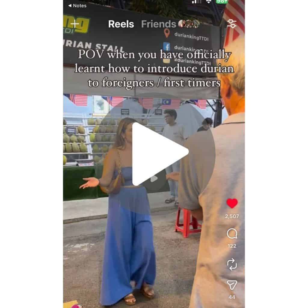 A screenshot of a viral video of girl getting foreigners to try durian for the first time
