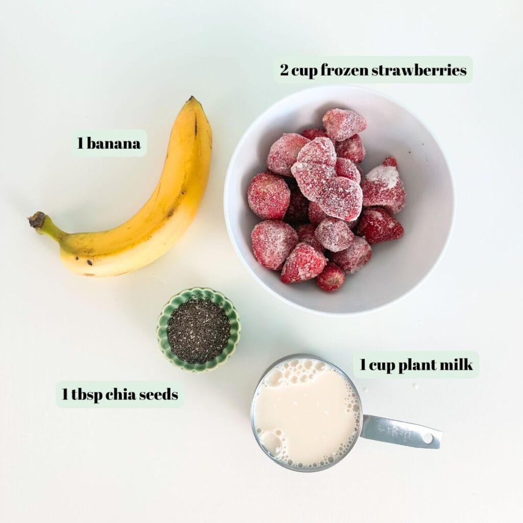 Ingredients for a healthy 4-ingredient strawberry banana smoothie recipe on a kitchen counter.