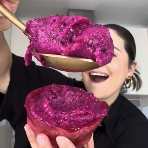 Easy dragon fruit sorbet recipe scooped into a fresh dragon fruit shell made without an ice cream maker