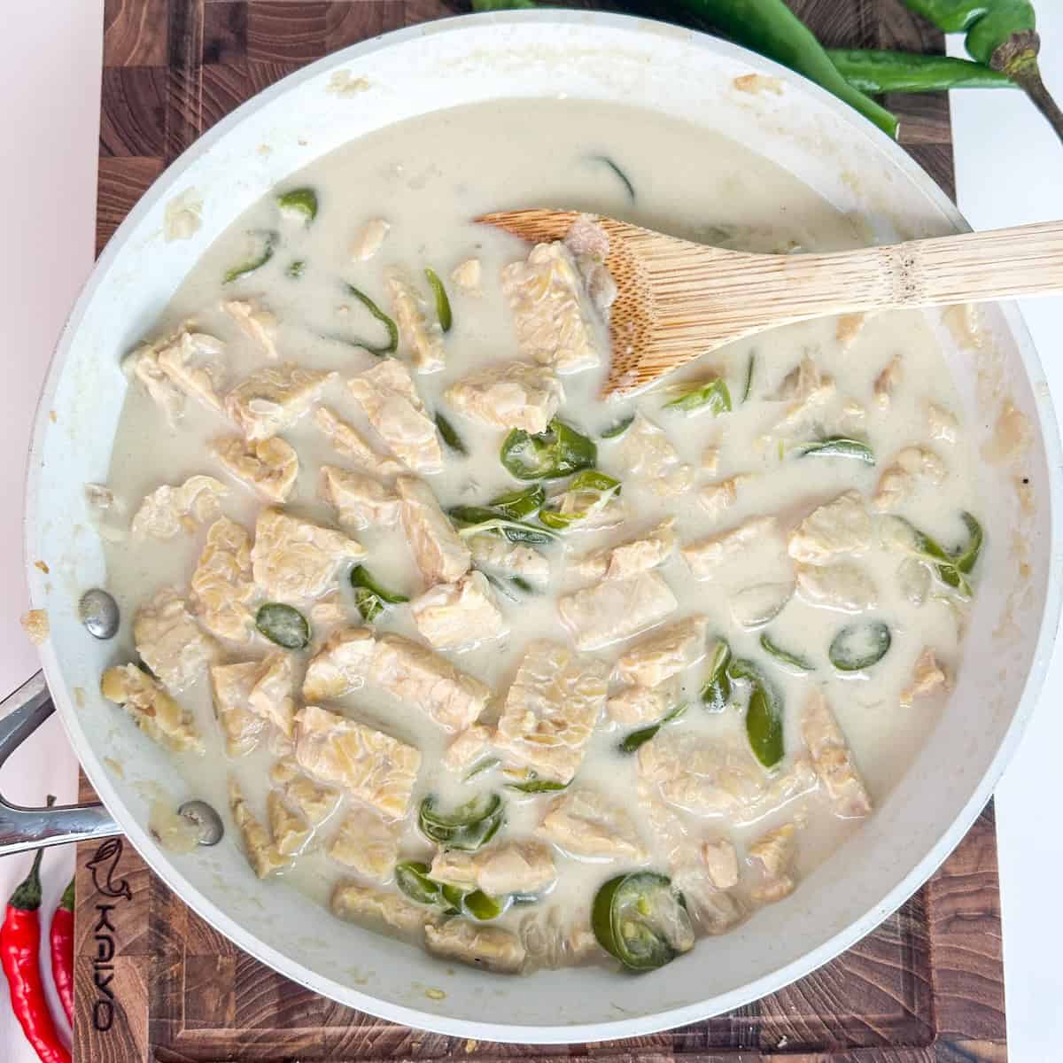 One-pot green curry tempeh in a creamy coconut milk broth with green chillies and fresh herbs.