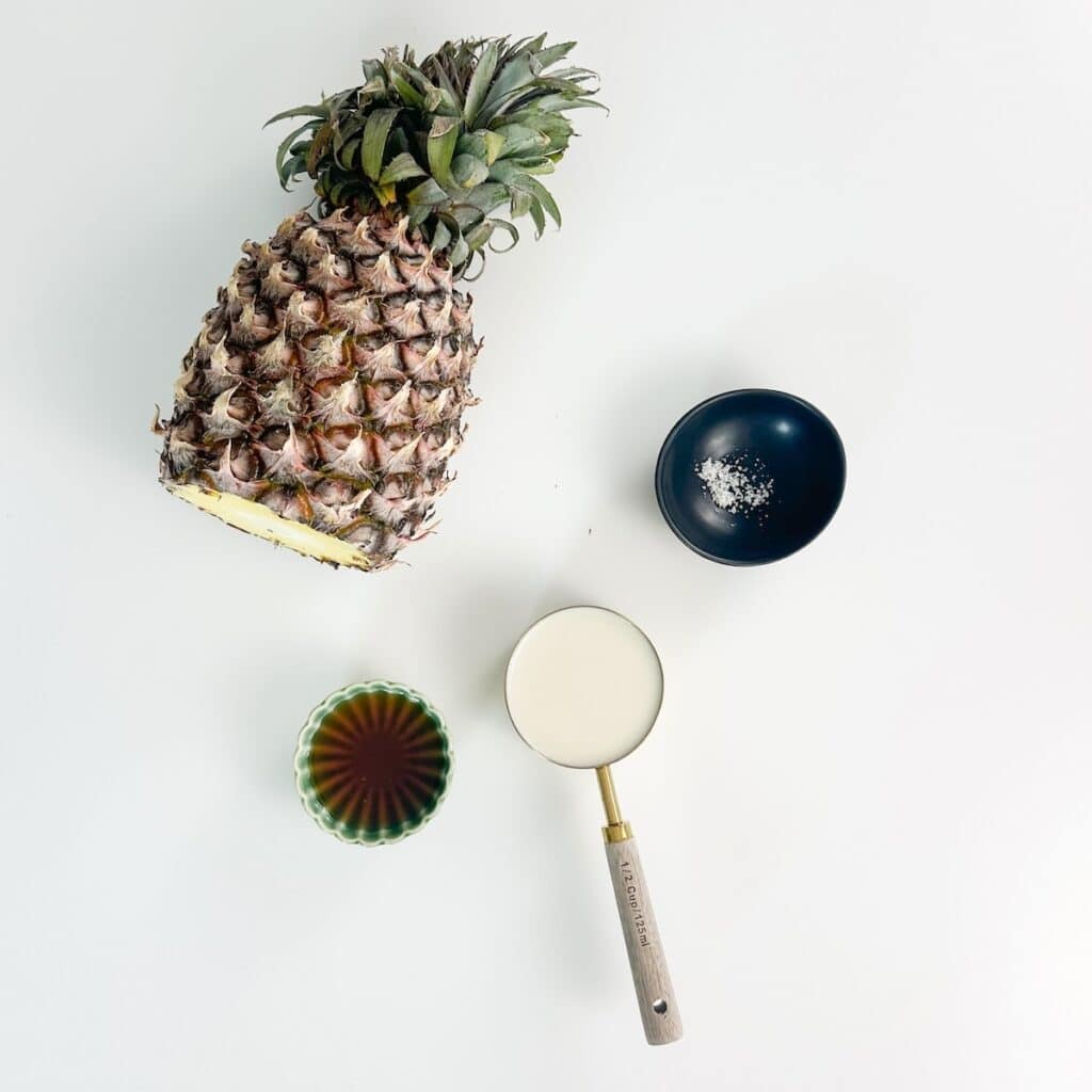 Pineapple, coconut cream, maple syrup and salt for a dairy-free Dole Whip recipe.
